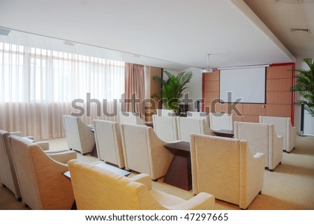 Small video conference room with sofas and movie projector