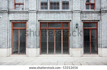 Detail of old Chinese style building facade with arch doors and colorful windows in a town.This is architectural style in the begin of last century\'s.