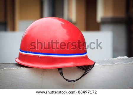 Red hard hat on a wall at a constuction site