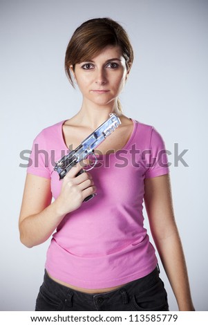 Powerful young woman with a gun