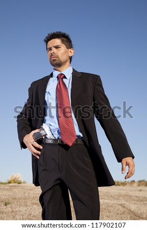 Powerful businessman with a gun in outdoor