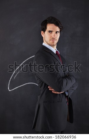 Businessman with a shark fin draw on the blackboard