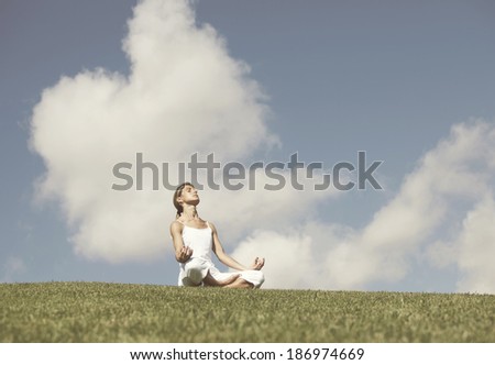 young woman enjoying nature in a yoga pose