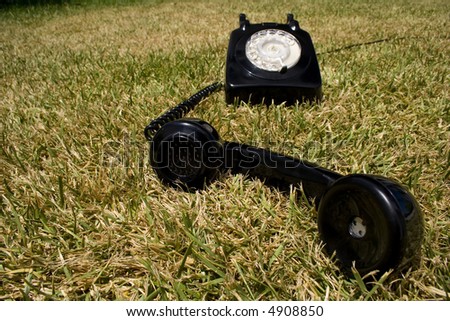 an old telephone on a green grass