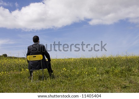 Businessman back sitting in a yellow chair
