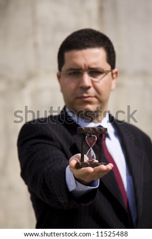 a businessman showing how to save time (selective and soft focus)