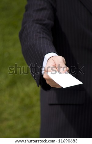 Businessman showing a blank card with copy space (selective and soft focus)