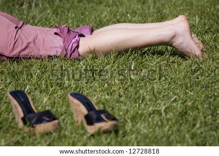 woman legs resting in the grass (selective and soft focus)