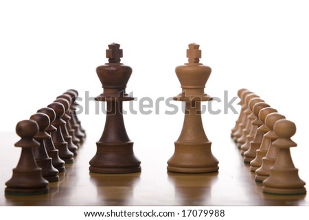 the king and the queen piece of a chess table ready for it\'s move (selective focus)