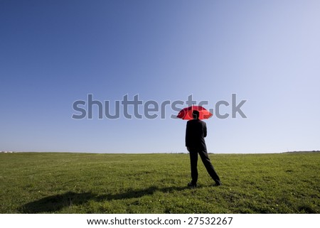 Businessman finding protection outside in the field