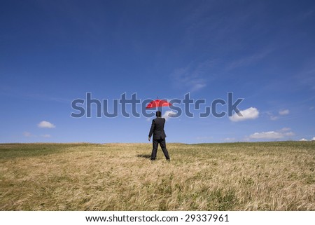Businessman finding protection outside in the field