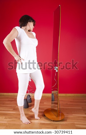 woman looking at her reflection on the mirror in her house