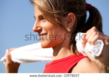 woman cleaning her sweat with a towel