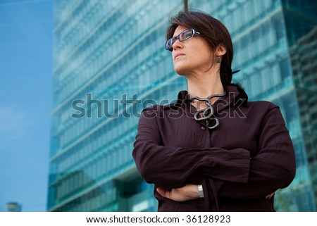 successful businesswoman looking away next to her office building