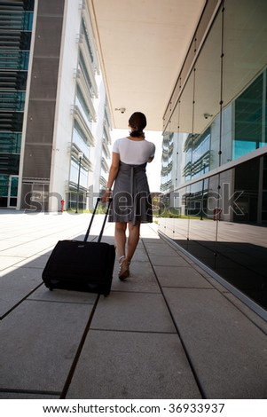 businesswoman walking with her luggage