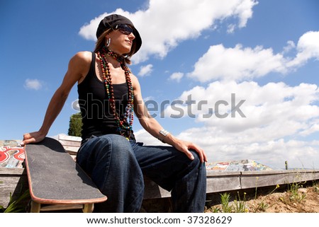 cool skateboard woman at a public graffiti park