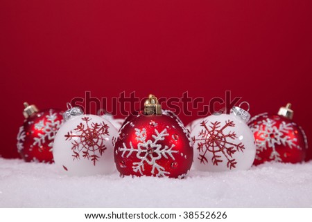red and white christmas balls with a red background (selective focus)
