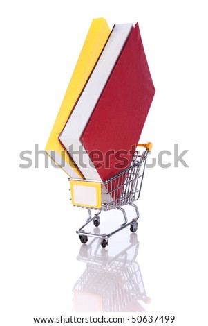 Stack of color books and a shopping cart (isolated on white)