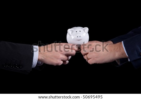 Two businessman competing for money, pushing a piggy bank (isolated on black)