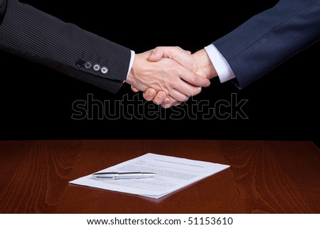 handshake between two businessman after closing the contract