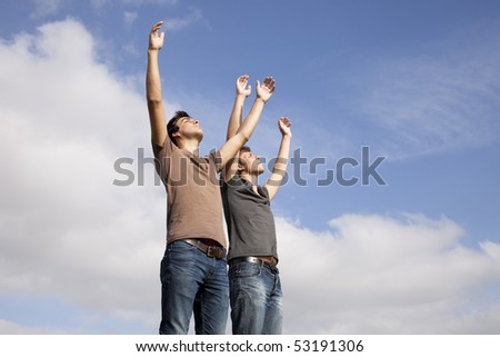 two young teenager with the arms outstretched in outdoor