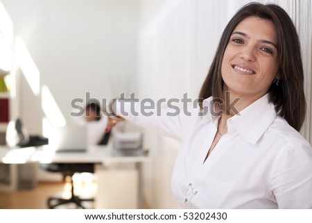 Business leader woman pointing to her relaxed employee  (selective focus with shallow DOF).