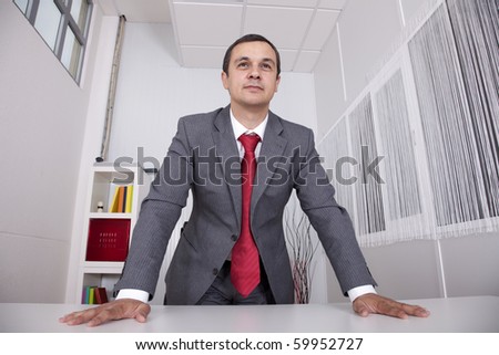 Modern and powerful businessman at his office