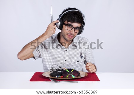 Crazy young man eating music at his dinner plate