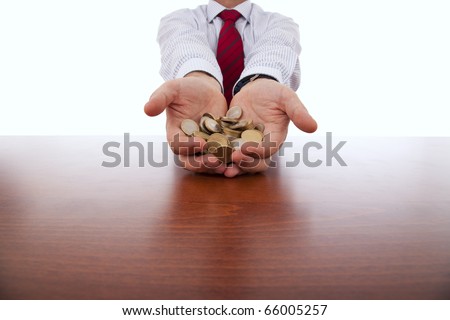 businessman showing a lot of coins in his hands
