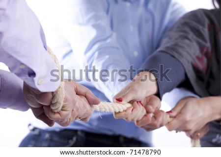 Group of woman hands pulling a rope competing with a man (selective focus)