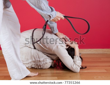 stock-photo-men-threating-and-beating-his-wife-at-home-with-a-belt-77351266.jpg