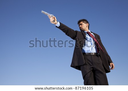 Powerful businessman with a gun in outdoor