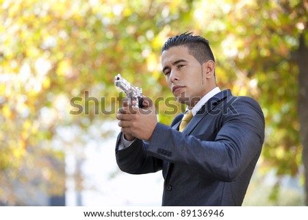 Powerful security businessman aiming a gun