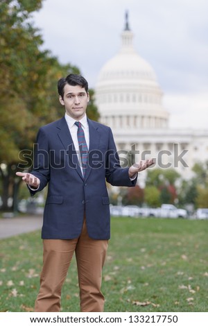 Man Standing In Front Of US Capitol Holding Up His Hands In Defeat