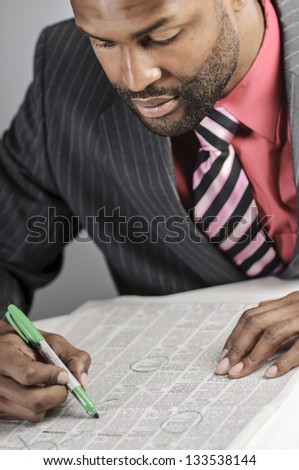 African American Man Hunting For A Job In The Classifieds