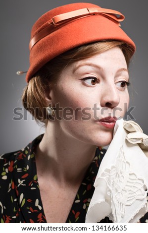 Retro woman dabbing her mouth with a handkerchief