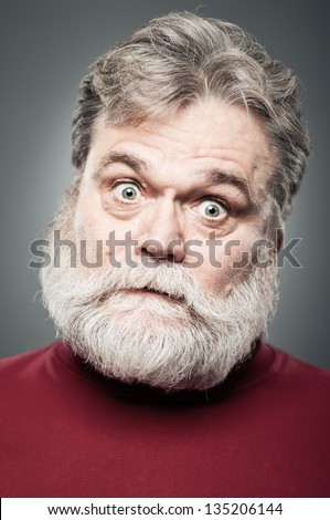 A mature man in his 50\'s wide eyed and crazy.