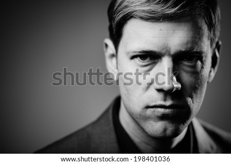 Handsome man portrait with an evil smirk