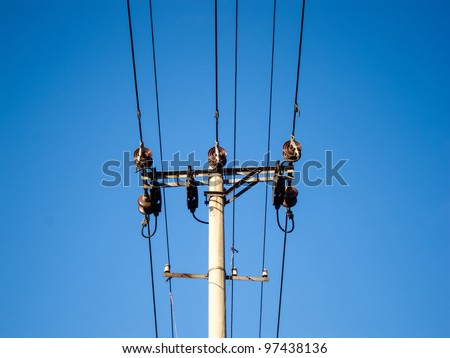 Wire pole on the blue sky background
