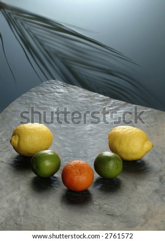Whole citrus fruits in a semicircle on a stone table
