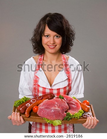 Young woman offers meat traditional products, isolated on grey background
