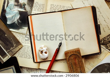 Vintage background with old note-book, books, postcards, photographs, pen, wooden pen-case and stone