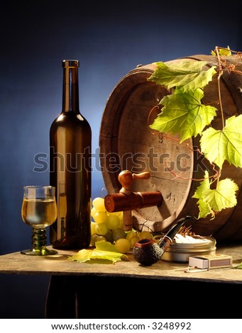 Still-life with white wine, a cask, a grapevine and a pipe on blue background
