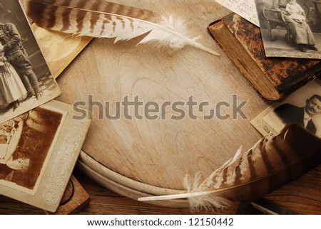 Vintage background with old photographs and feathers
