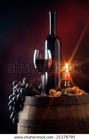 Still life with red wine and candle