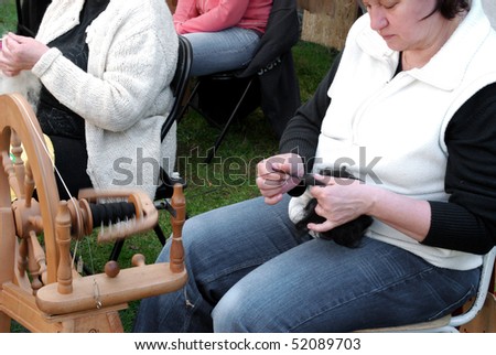 RATIBORICE, CZECH REPUBLIC - APRIL 24:  Older woman spinning wool on traditional spinning wheel - The Shepherds Festival 2010,  on April 24, 2010 in Ratiborice, Czech Republic