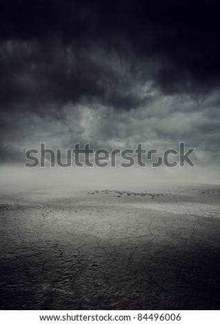 storm landscape with dry cracked land
