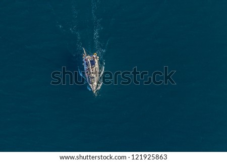 Helicopter aerial shoot of sailboat in a sea channel, location: Croatia.
