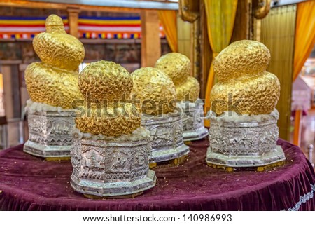 INLE LAKE, MYANMAR - FEBRUARY 28: Many years of devotees adding small pieces of gold leaf has turned small buddha statues into amorphous blobs on February 28, 2013 in Inle Lake, Myanmar.