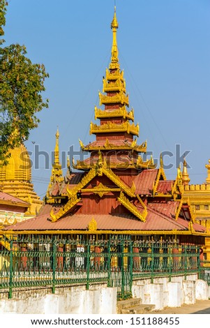 One of the temples in Shwezigon Pagoda complex early in the morning before prayers and tourist arrive. Shwezigon in Nyaung-U, Myanmar was built A.D 1076 as the most important reliquary shrine in Bagan